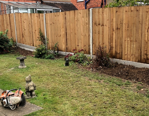 Panel fencing with concrete posts.