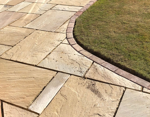 Curved patio with blockwork edge.